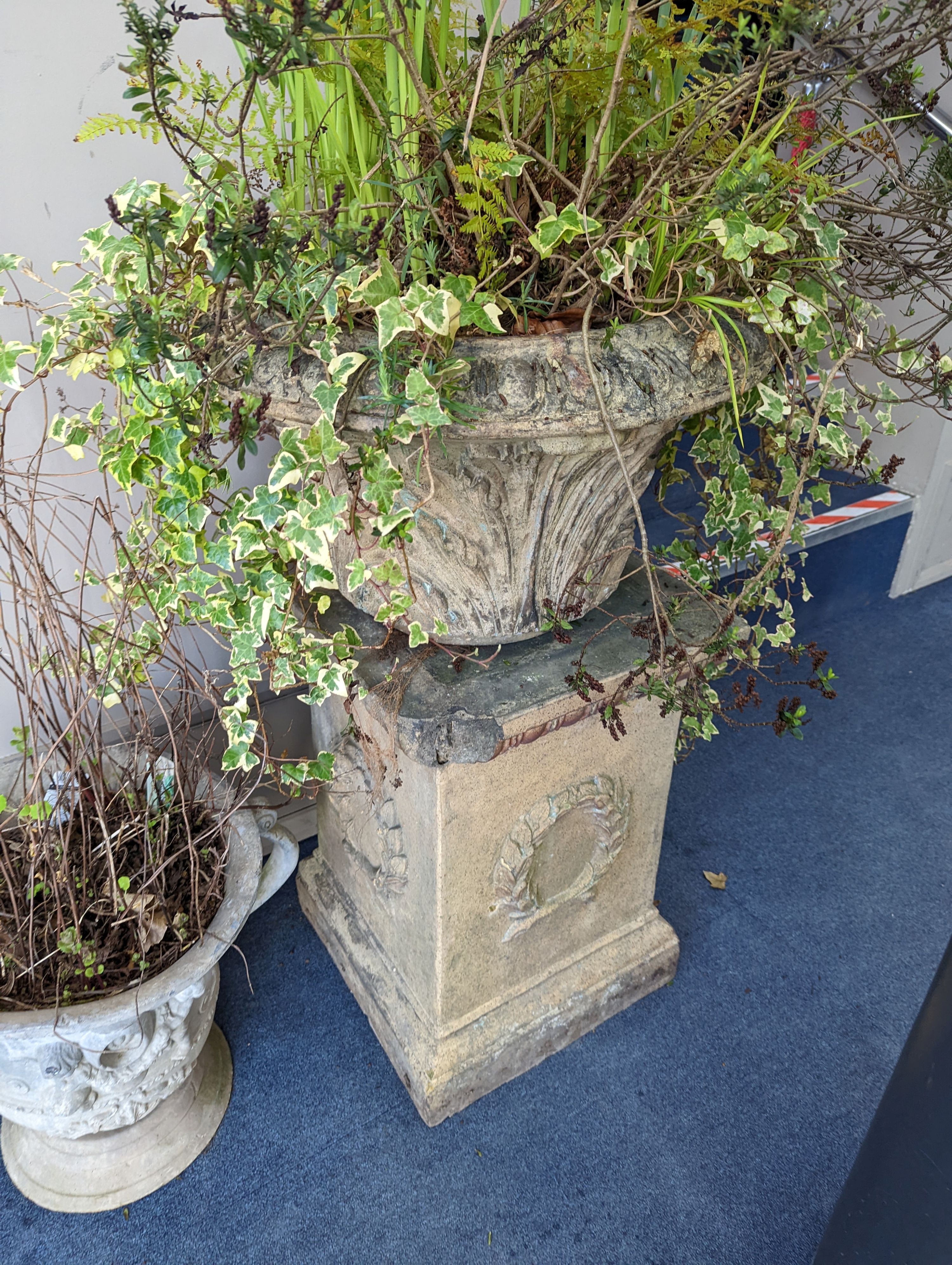 A pair of Victorian earthenware circular garden urns square plinth bases, diameter 58cm, height 96cm